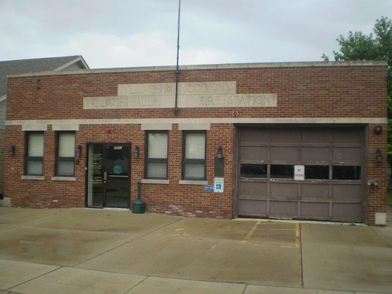 Alt text: Exterior view of the Village of Hodgkins Village Hall and Fire Station, featuring a brick facade and accessible entrance.