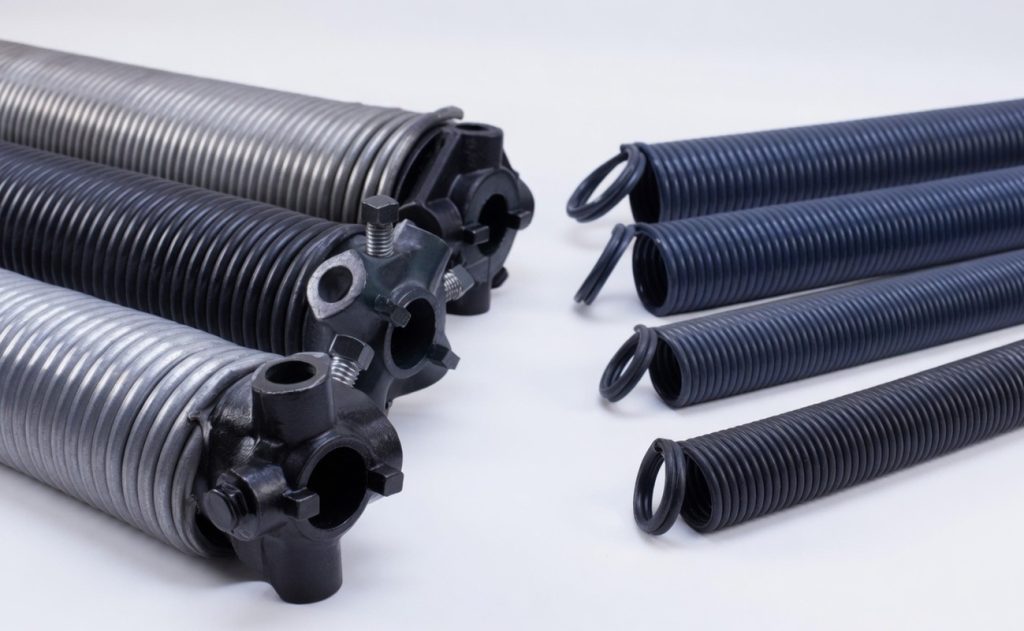 Close-up of various metal and rubber industrial springs, showcasing different sizes and designs for mechanical applications.